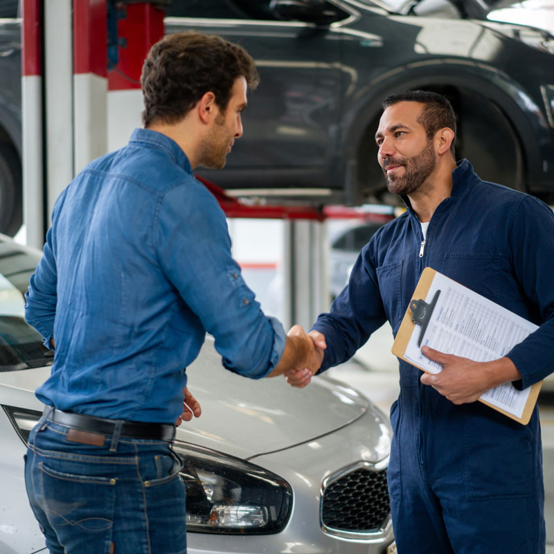 customer shaking hands with mechanic