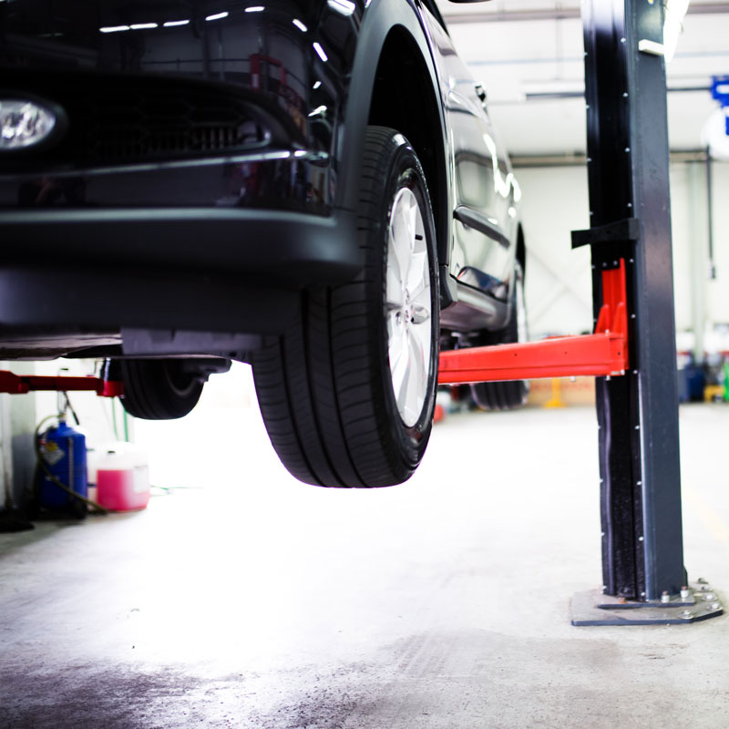 car lifted in auto body shop